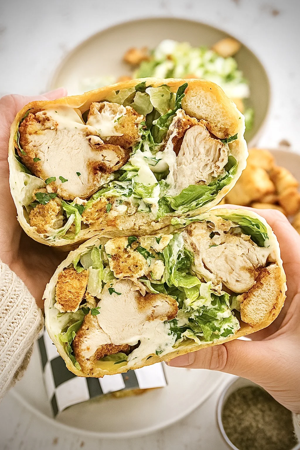 Close view of chicken caesar wraps filled with grilled chicken, lettuce, and Caesar dressing