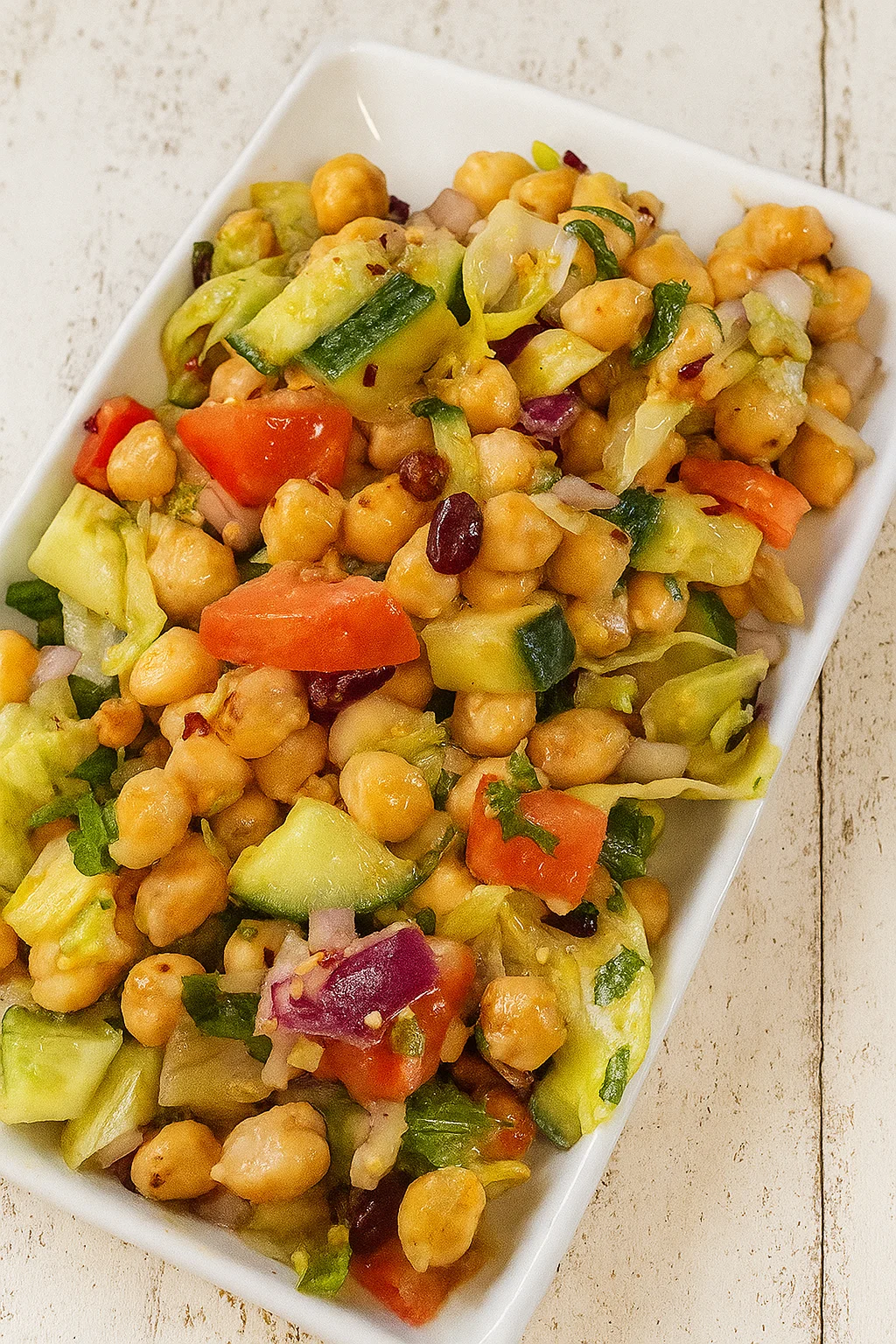 Fresh chickpea and avocado salad with tomatoes and herbs
