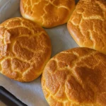 fluffy cottage cheese cloud bread on parchment lined baking tray