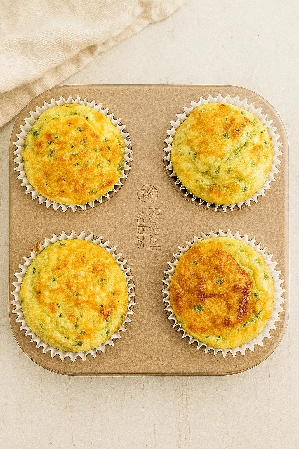 Freshly baked cottage cheese egg muffins in a muffin tray