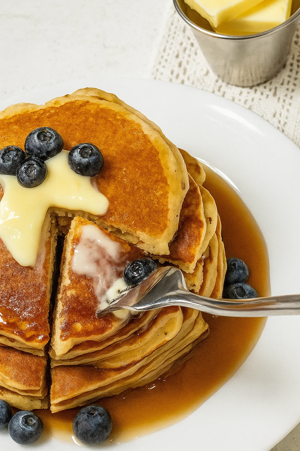 Fluffy cottage cheese pancakes stacked and served on a plate