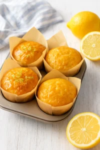 Freshly baked honey lemon yogurt muffins in a baking tray