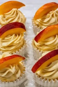 Honey peach cream cheese cupcakes topped with peach slices