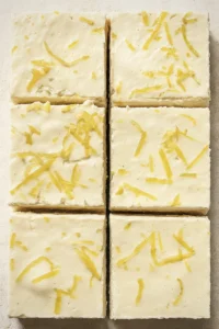 Lemon cream cheese bars with buttery crust, cut into squares