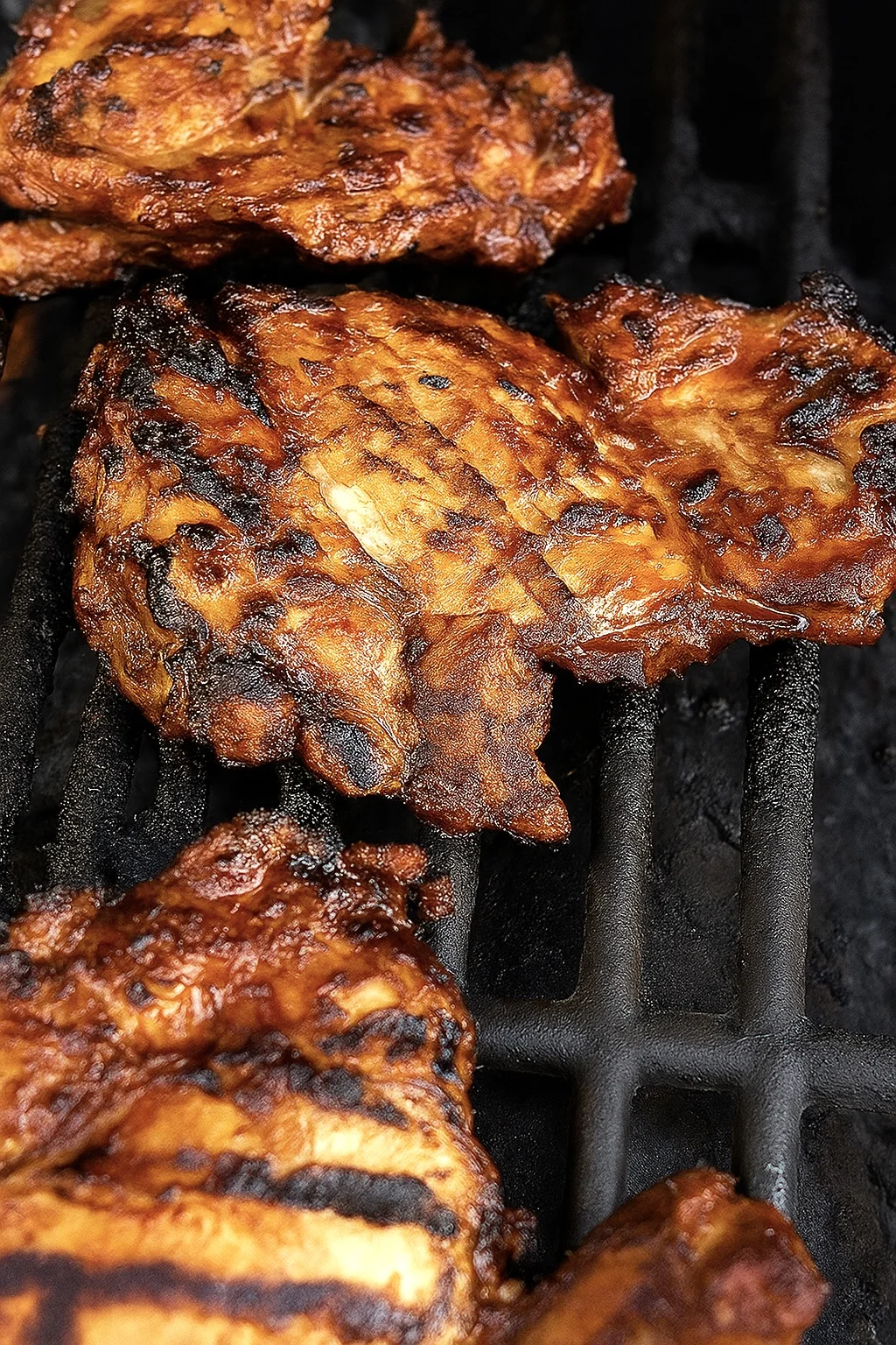 Close up of maple chipotle grilled chicken sizzling on the grill