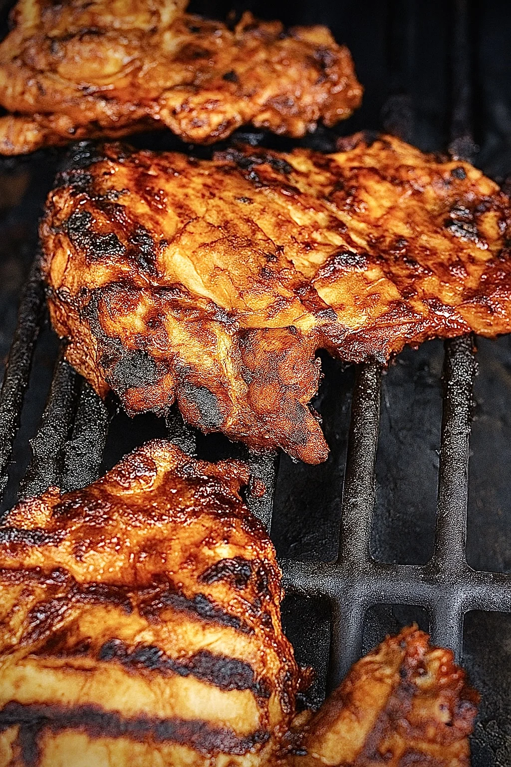 Maple chipotle grilled chicken cooking on a grill