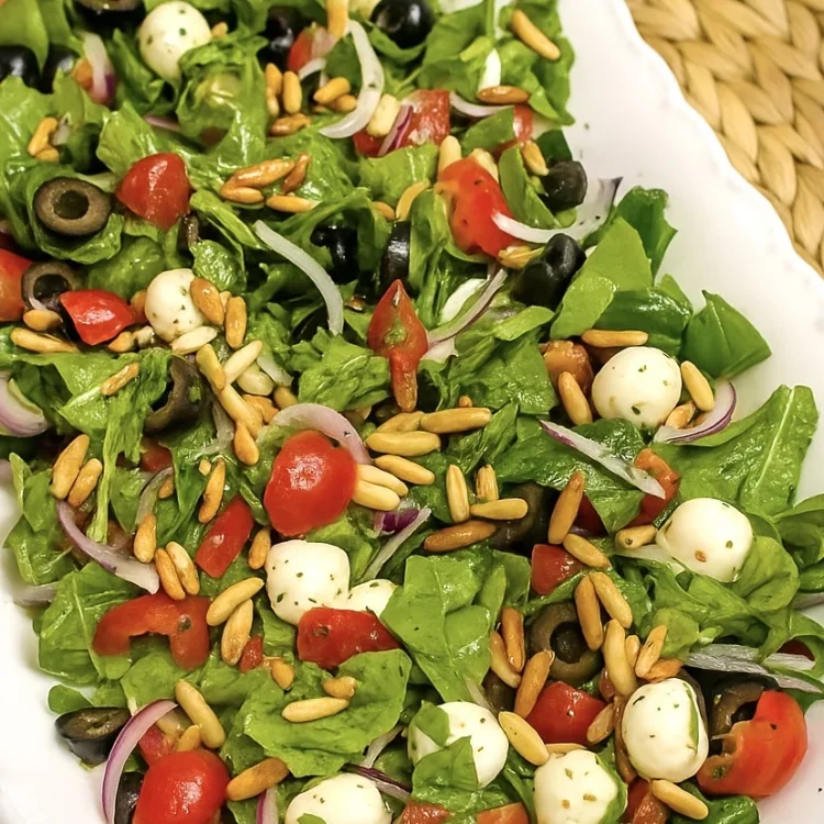 Fresh lemon arugula salad served in a tray
