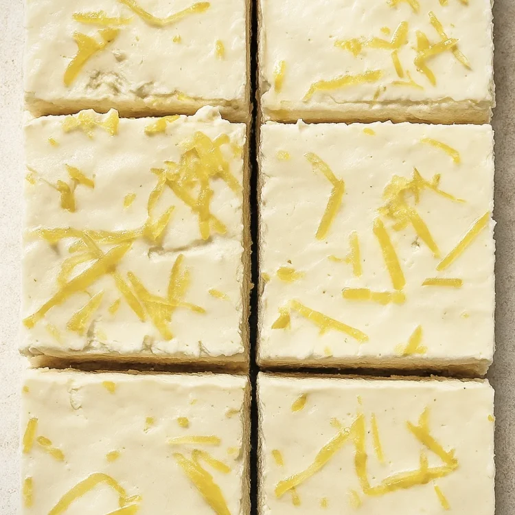 Lemon cream cheese bars with buttery crust, cut into squares